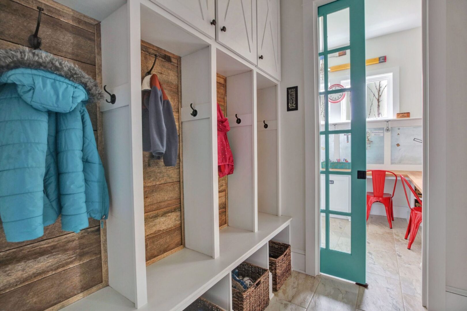 A room with many shelves and hooks for coats