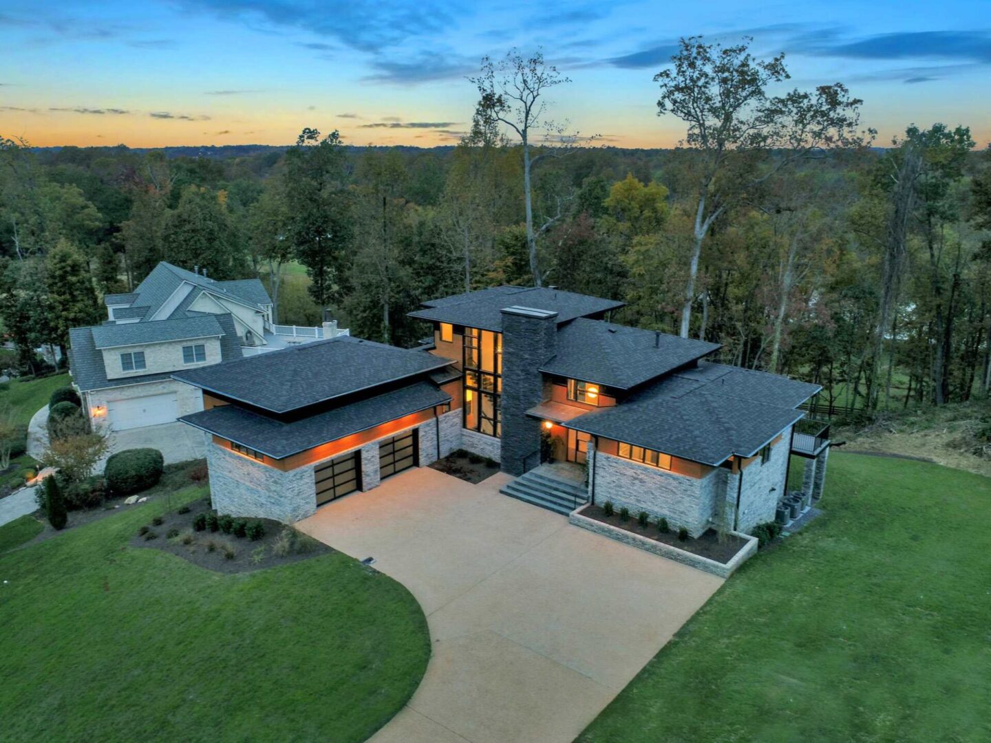 A large modern home with an aerial view of the house.
